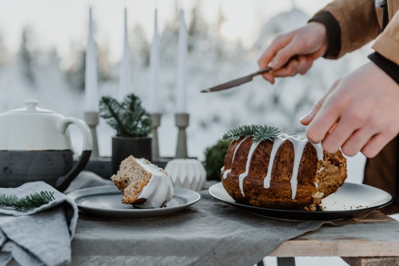 a person is cutting a bundt cake on a table
